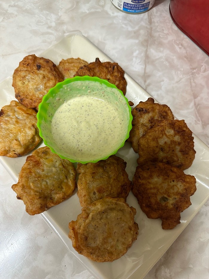 These are delicious codfish cakes next to my own homemade sauce to dip in