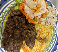 This is veal chops with carrot rice next to macaroni salad. The veal is well seasoned with a hint of my green seasonings