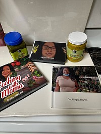 These are my picture books that display my food creations from 2017 to 2022. And the green seasonings on the left is used on meats and fish to add a delicious Caribbean twist to your dishes . And on the right is the curry marinade whichIs made with different spices and herbs and natural juices.these sauces elevate your meals.