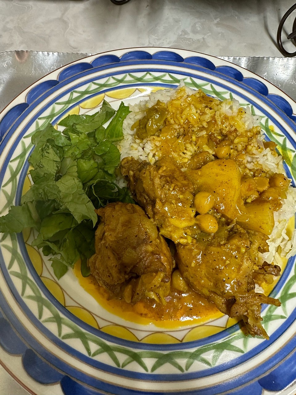 The curry chicken with the rice and salad